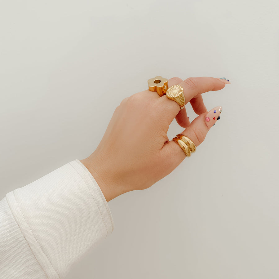 a stack of gold rings on all fingers